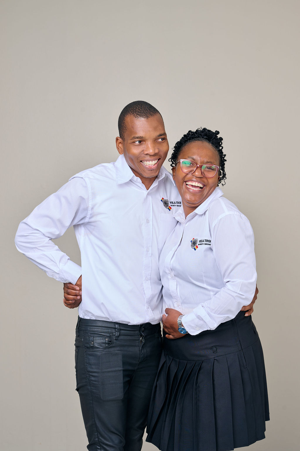 Two Vela-Tech Security head office staff members laughing together